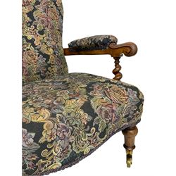 Victorian walnut framed open armchair, scrolled arm terminals over spiral turned arm supports, upholstered in foliate patterned fabric with sprung seat, on turned supports and brass castors (W65cm H92cm); and Victorian mahogany nursing chair with lobe carved supports (W60cm H92cm)