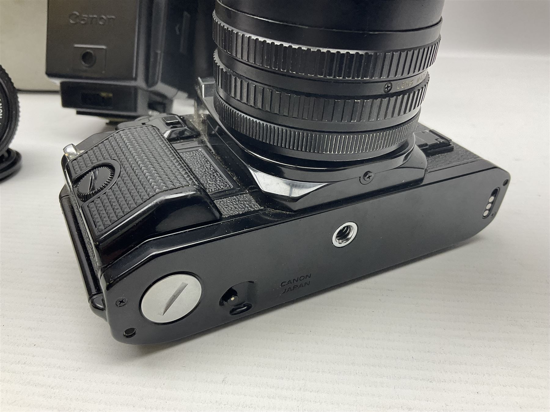 Canon A1 35mm camera body serial no 741264, with 'Tokina AT-X 28-85mm 1:3.5-4.5' lens serial no 821679, 'Canon FD 50mm 1:1.8mm' lens and other camera equipment 