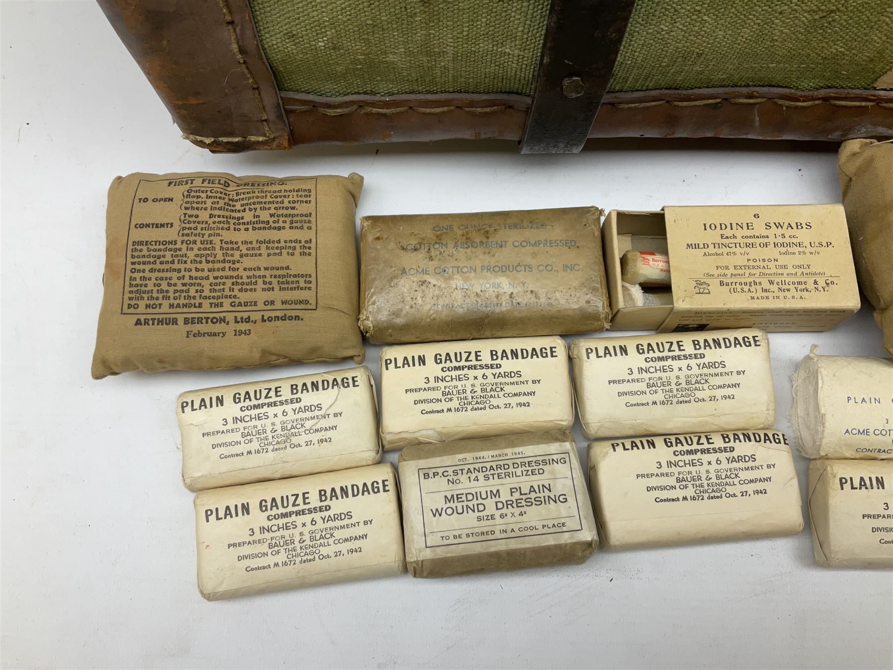 WW2 British Army RAMC 'Regimental Medical Pannier', well marked externally and dated 1941, stamped May 1943 internally, canvas covered wicker form with leather edges, hinged top and fall front with two rope carrying handles, fitted iron locking straps with securing chains; contains various unused field dressings and bandages with WW2 dates and two pillows; original label under lid L79cm