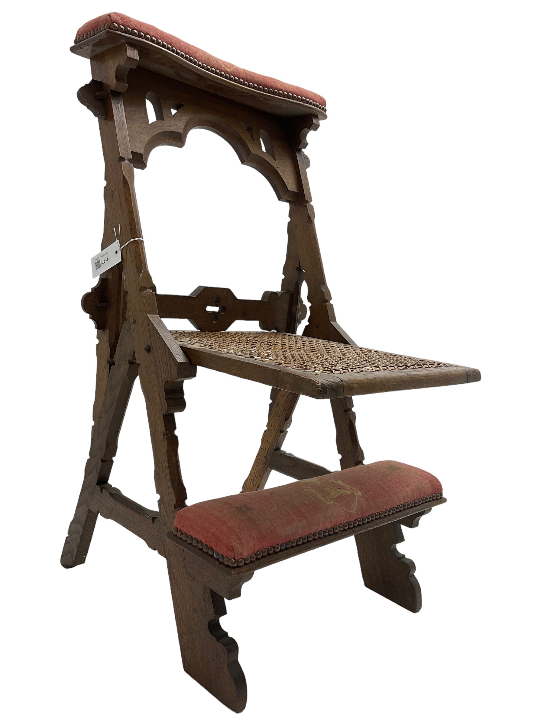 Late Victorian oak metamorphic prie-dieu chair, ecclesiastical design with pegged construction, upholstered kneel rest and top rest, hinged cane work seat