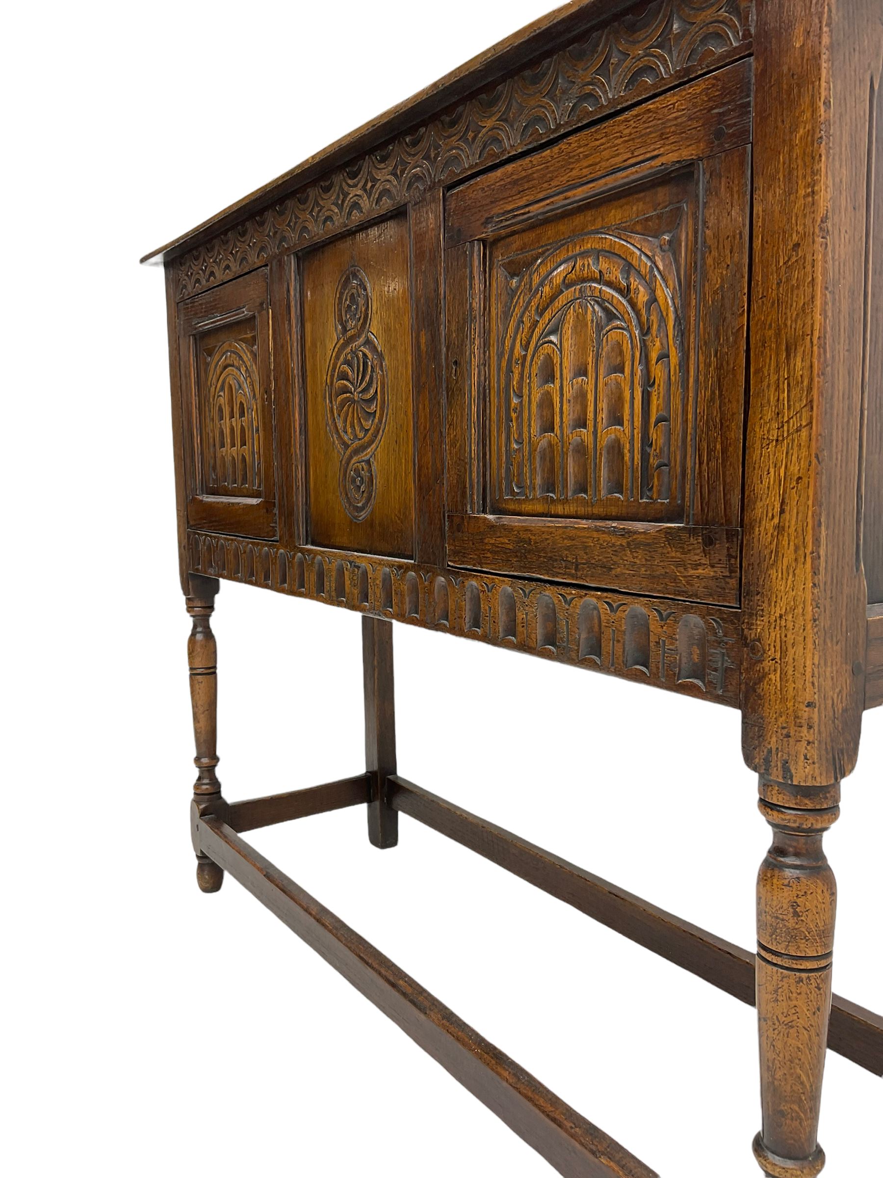 17th century style caved oak side cabinet, fitted with two cupboards, stretcher base