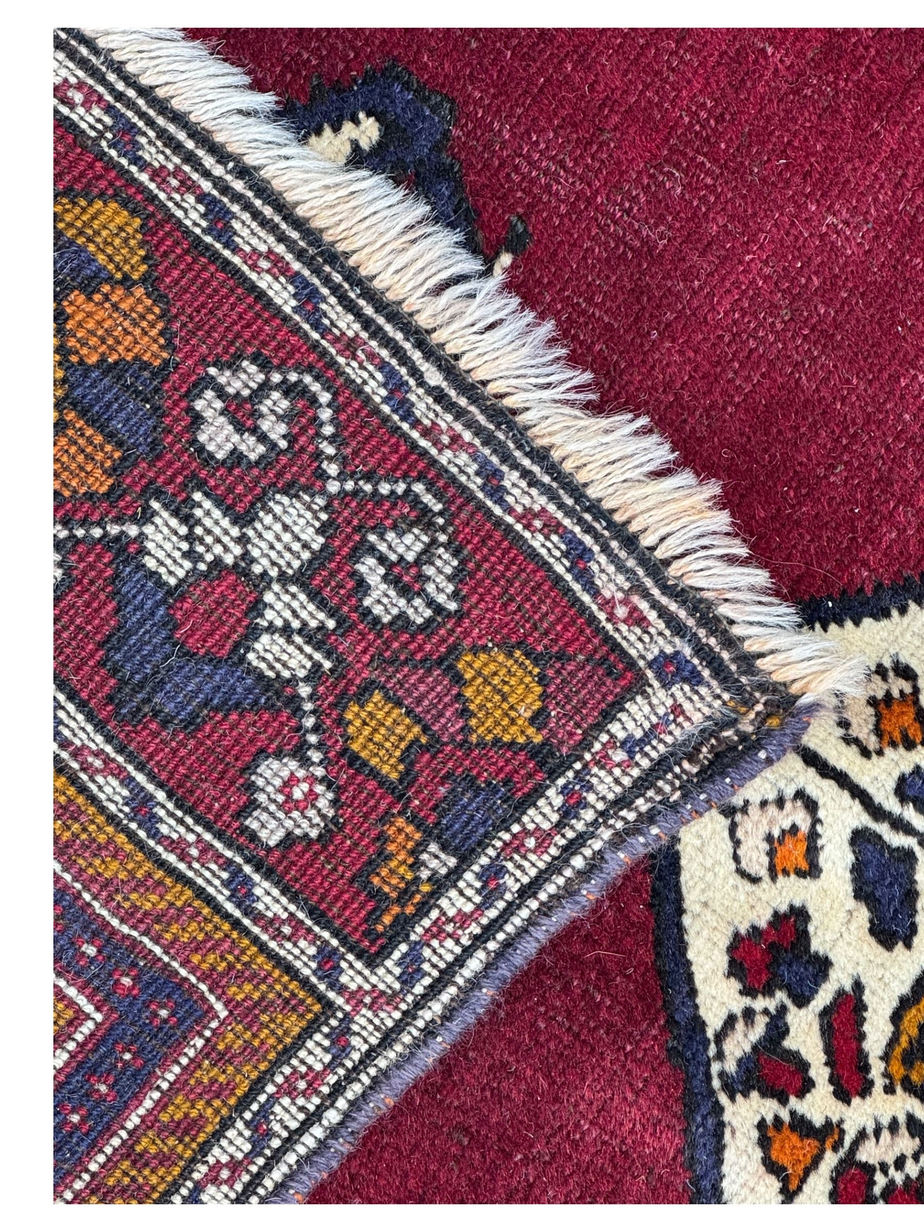 West Persian Hamadan rug, hand knotted, central medallion bordered by geometric and intricate floral motifs, displaying red cream and indigo colours with an orange coloured border  