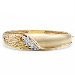 14ct yellow and white gold cubic zirconia abstract design hinged bangle, stamped 585