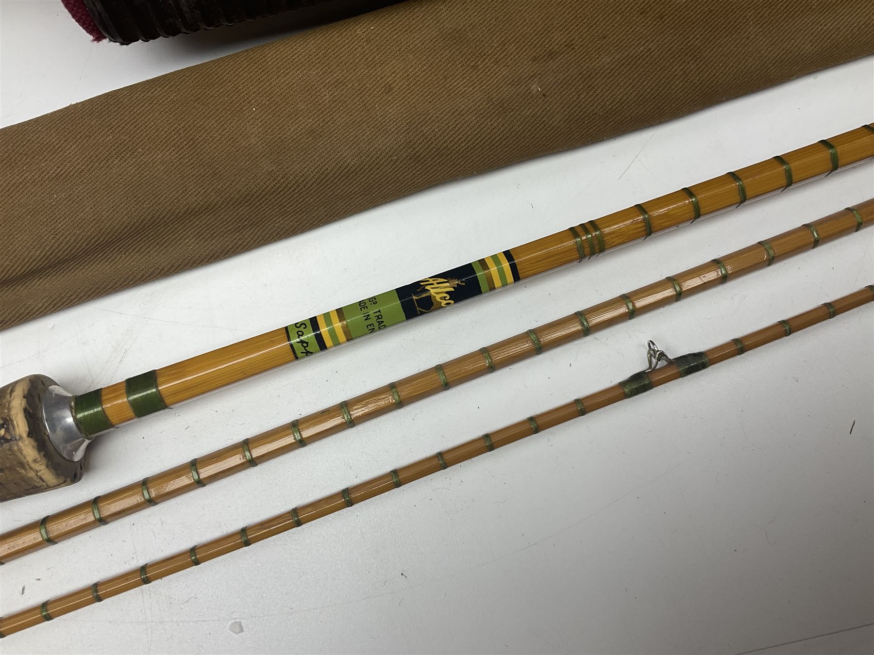 Collection of fishing memorabillia and equipment, including an Allcocks three piece split cane trout fly rod, Shakespeare Salt 3600 surf rod, two tackle bags, Old Red Seastreak multiplier reel, Sportext Saltwater fixed spool reel, fishing dvds, etc