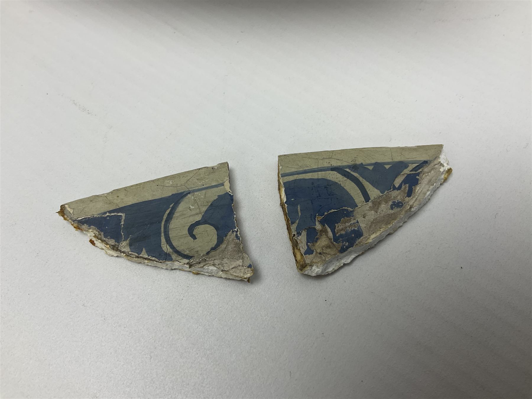 Early 18th century Delft marriage plate, of circular form with dished centre, the centre inscribed and dated 'Thomas and Elizabeth Kockerill Bridlington Key 1715' within a crowned C scroll cartouche, flanked by demi-griffins, above a putto head and tassels, within a wide foliate border, D34cm
