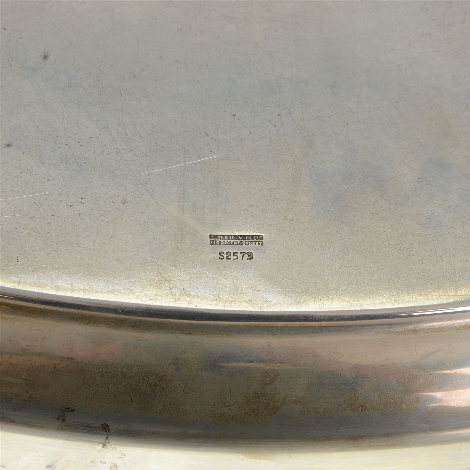Modern silver twin handled serving tray, of oval form with stylised bud and tendril detail to rim, hallmarked Garrard & Co Ltd, Sheffield 1970, also impressed Garrard & Co Ltd 112 Regent Street beneath, including handles L64cm
