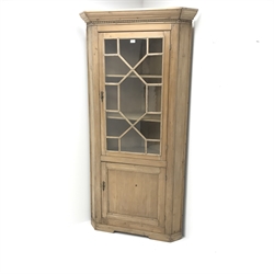   19th century pine corner cabinet, projecting cornice, astragal glazed door enclosing shelves above single panelled doors, shaped plinth base, W102cm, H199cm, D52cm   
