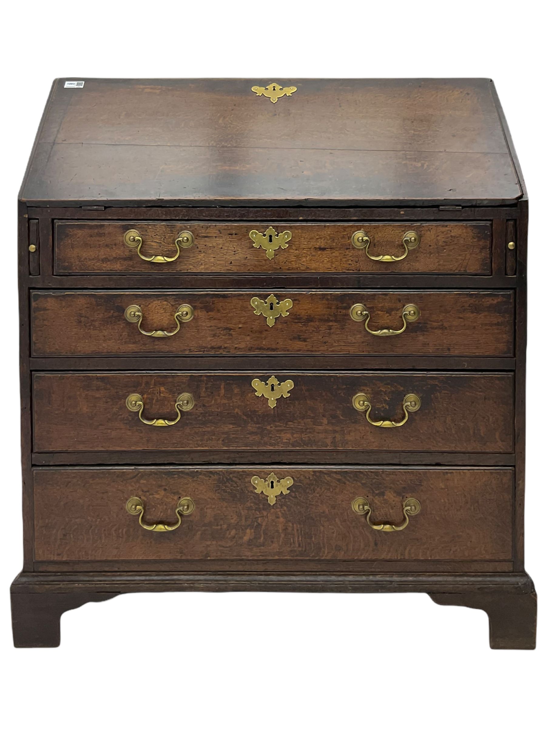 Georgian oak bureau, fall front enclosing fitted interior, four long graduating drawers, on bracket feet