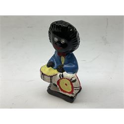 Robinson Jam plaster Golly band, including drummer and singer, H7.5cm

Originally handmade by mothers in Africa for their children from old fabric and cloth, the golly doll was adopted as the mascot and trademark for the Robertson's confectionery brand around 1910 after the company's founder John Robertson visited the US and noticed children playing with them. Robertson's Gollies have been collected by people across the UK and around the world for generations but garnered a contentious image in the 1980s because of links to racism. The trademark was removed from Robertson's branding in 2001.