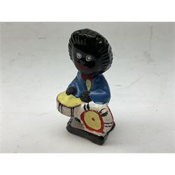 Robinson Jam plaster Golly band, including drummer and singer, H7.5cm

Originally handmade by mothers in Africa for their children from old fabric and cloth, the golly doll was adopted as the mascot and trademark for the Robertson's confectionery brand around 1910 after the company's founder John Robertson visited the US and noticed children playing with them. Robertson's Gollies have been collected by people across the UK and around the world for generations but garnered a contentious image in the 1980s because of links to racism. The trademark was removed from Robertson's branding in 2001.