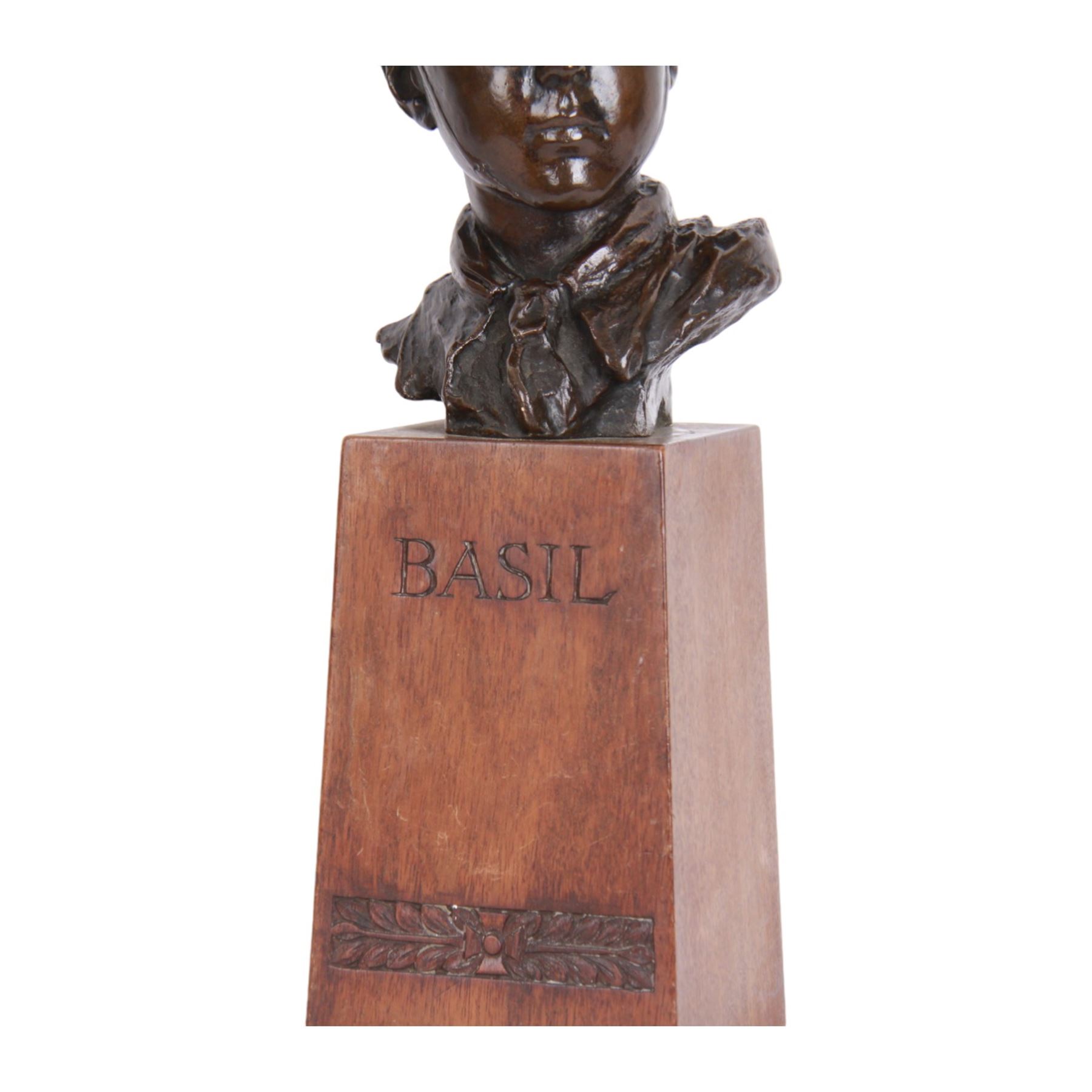 William Goscombe John (Welsh 1860-1952), bronze, bust of Basil Webb as a boy scout, upon a tall oak plinth inscribed BASIL above foliate band, titled to paper label verso and beneath, overall H36cm