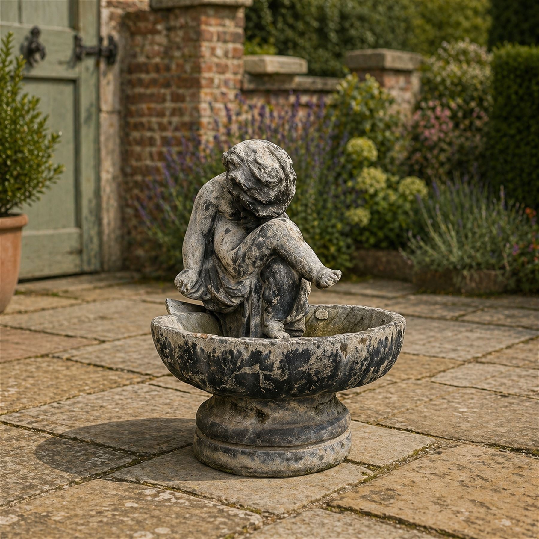 19th century lead bird bath depicting a seated cherub on a shell