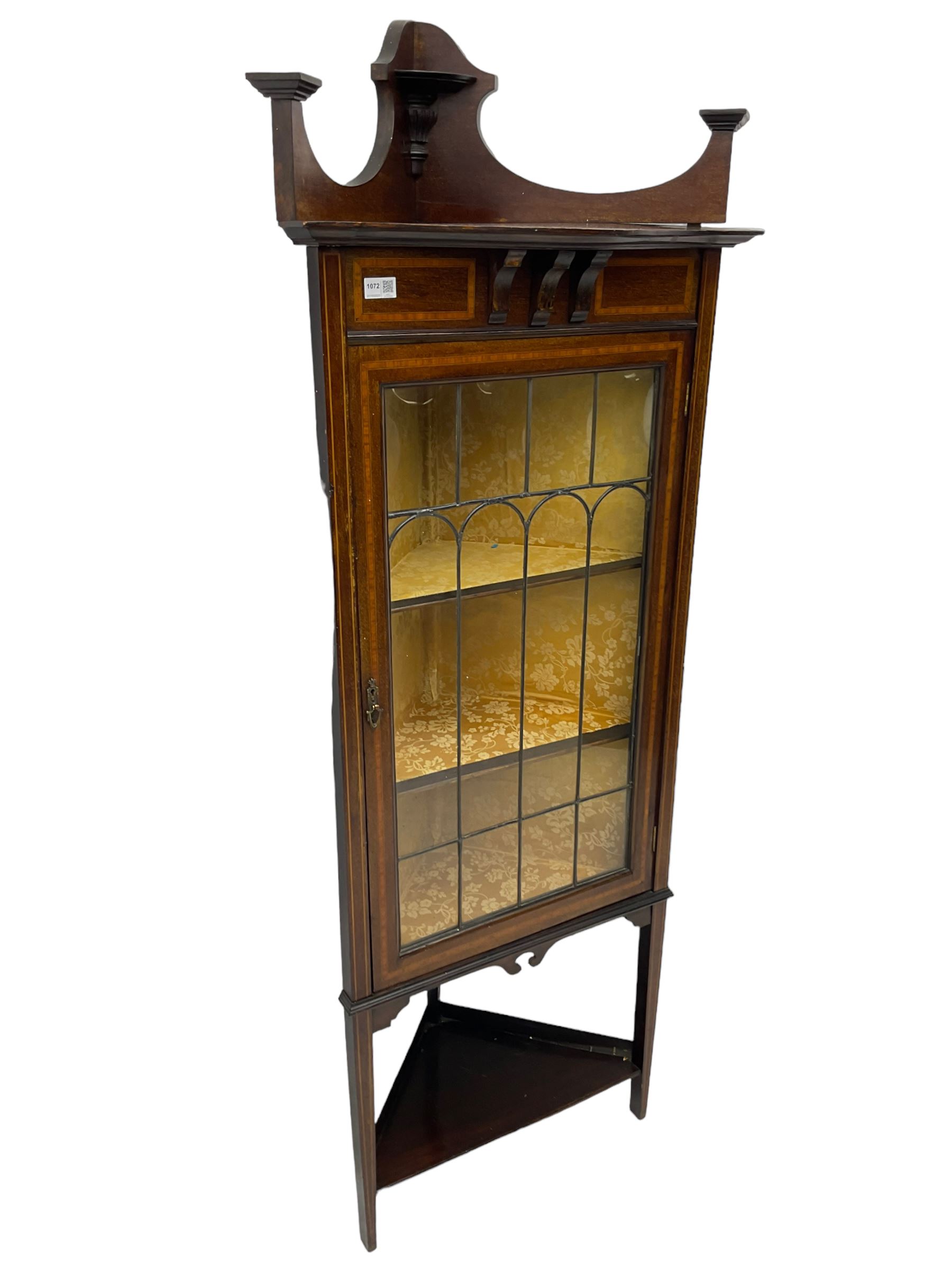 Edwardian inlaid mahogany corner cabinet, fitted with single astragal glazed door enclosing two shelves, flanked by satinwood banding, on square tapering supports united by undertier