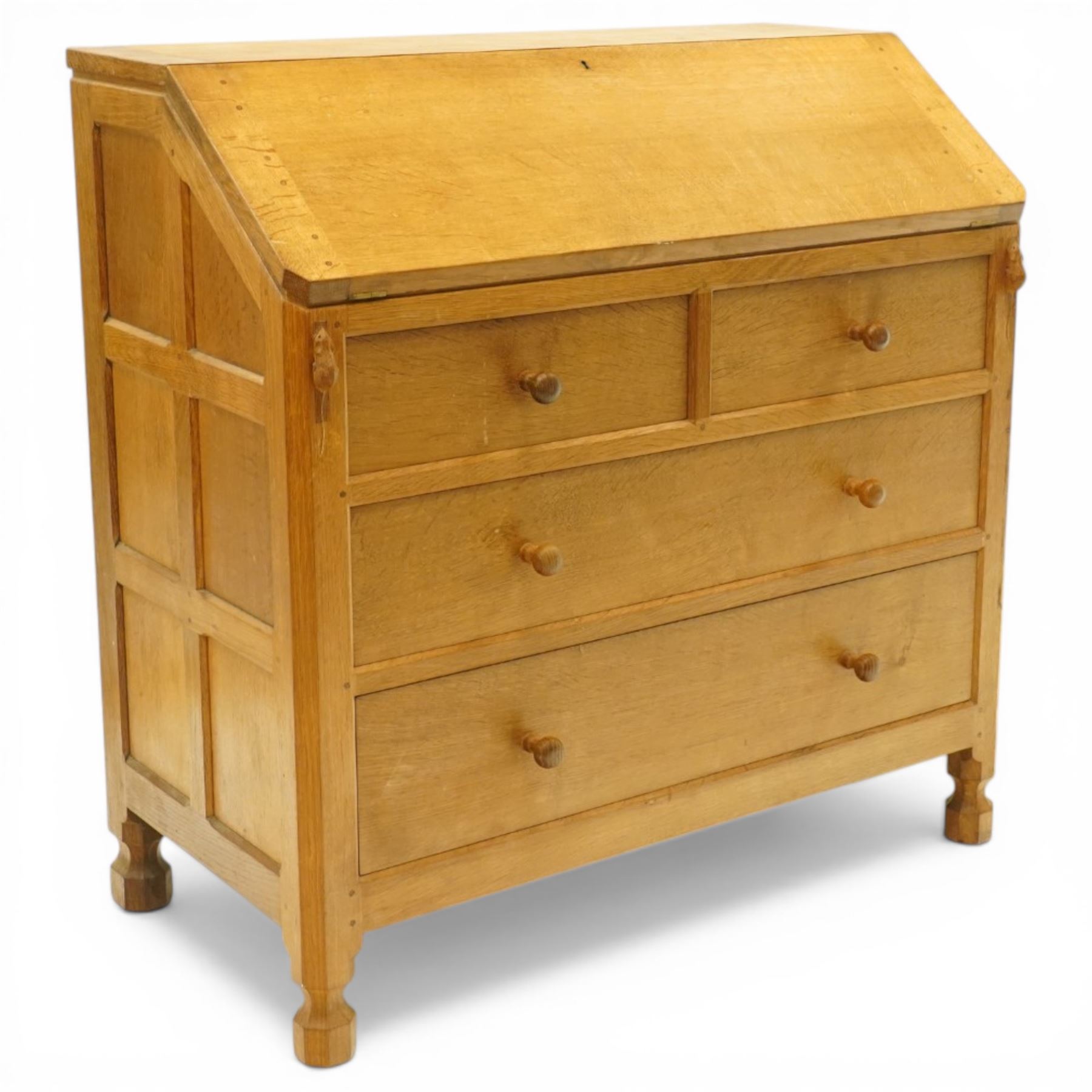 Mouseman - oak adzed bureau, fall front with carved mouse lopers, with fitted interior, above two short over two long drawers, by the workshop of Robert Thompson of Kilburn
