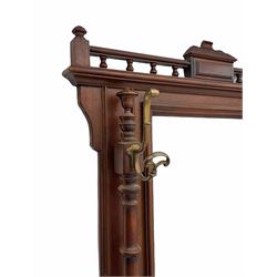 Victorian style walnut and beech hall stand, the gallery top over bevelled mirror and two upright turned pilasters fitted with hooks, hinged ‘letter’ compartment flanked by two umbrella stands, shaped and moulded base