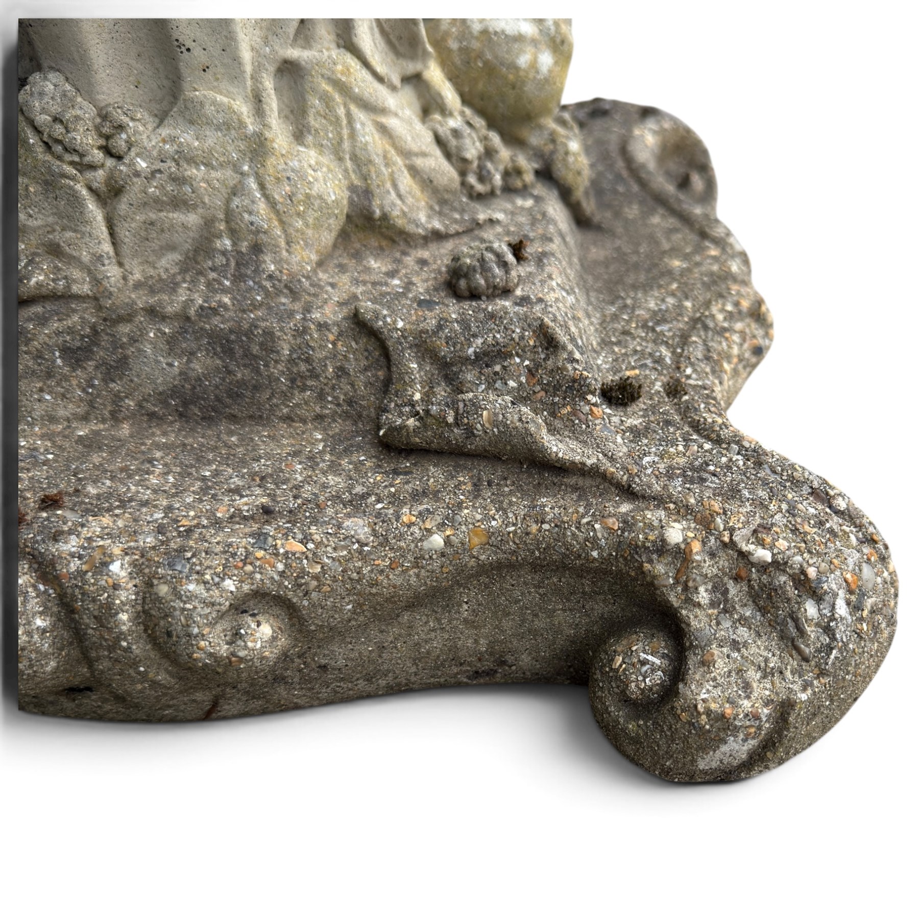 Weathered cast stone birdbath, the kylix shaped bowl with fluted body, raised on a fruiting foliate vine decorated fluted pedestal with upper knop and bird and fieldmouse motifs, shaped square base with scroll feet