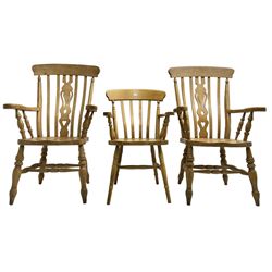 Pair of 20th century beech farmhouse design armchairs, pierced and shaped central splat over shaped saddle seat, raised on ring turned supports with H-stretcher; and a similar side chair