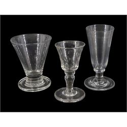 Large 19th century firing glass, the funnel bowl upon thick firing foot, H11cm, together with a further 19th century drinking glass, the funnel bowl cut with circles, upon a baluster stem and firing type foot, H11cm, and a 19th century dwarf ale glass upon a firing type foot, H13cm 