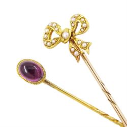 Two early 20th century gold stick pins, including a seed pearl set ribbon bow and cabochon...