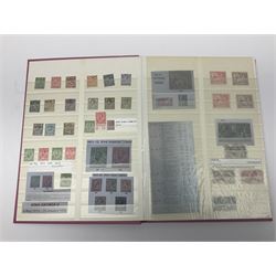 Mostly Great British stamps, including King Edward VII two shillings and sixpence, five shillings and ten shillings, King George V seahorses, King George VI high values, Queen Elizabeth II pre and post decimal etc, housed in a pink stockbook 