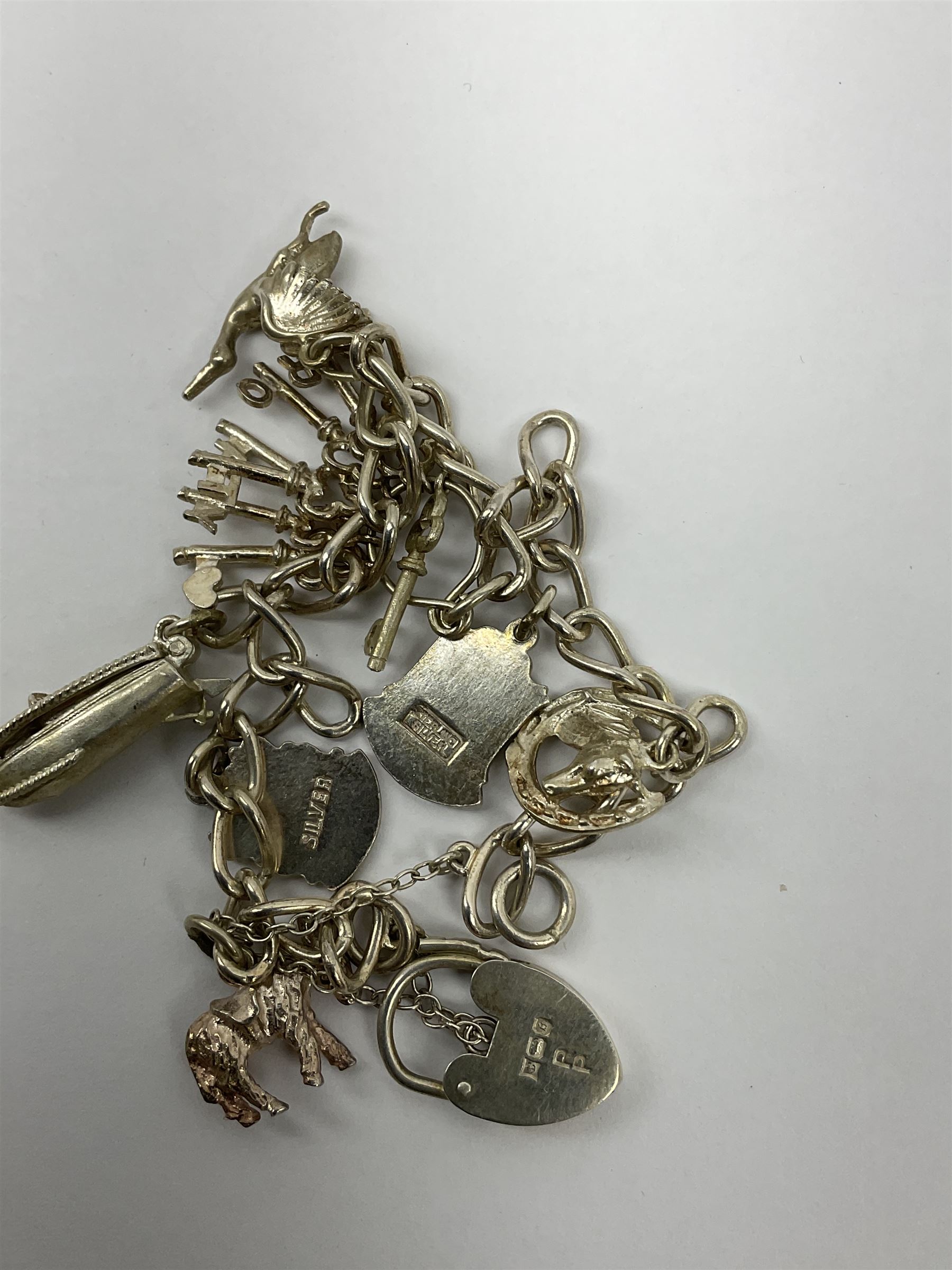 Two Klaus Kobec Entourage gentleman's and ladies, bicolour stainless steel quartz bracelet wristwatches, round white dials with Roman numerals and date apertures, both boxed, silver charm bracelet, silver jewellery and other costume jewellery