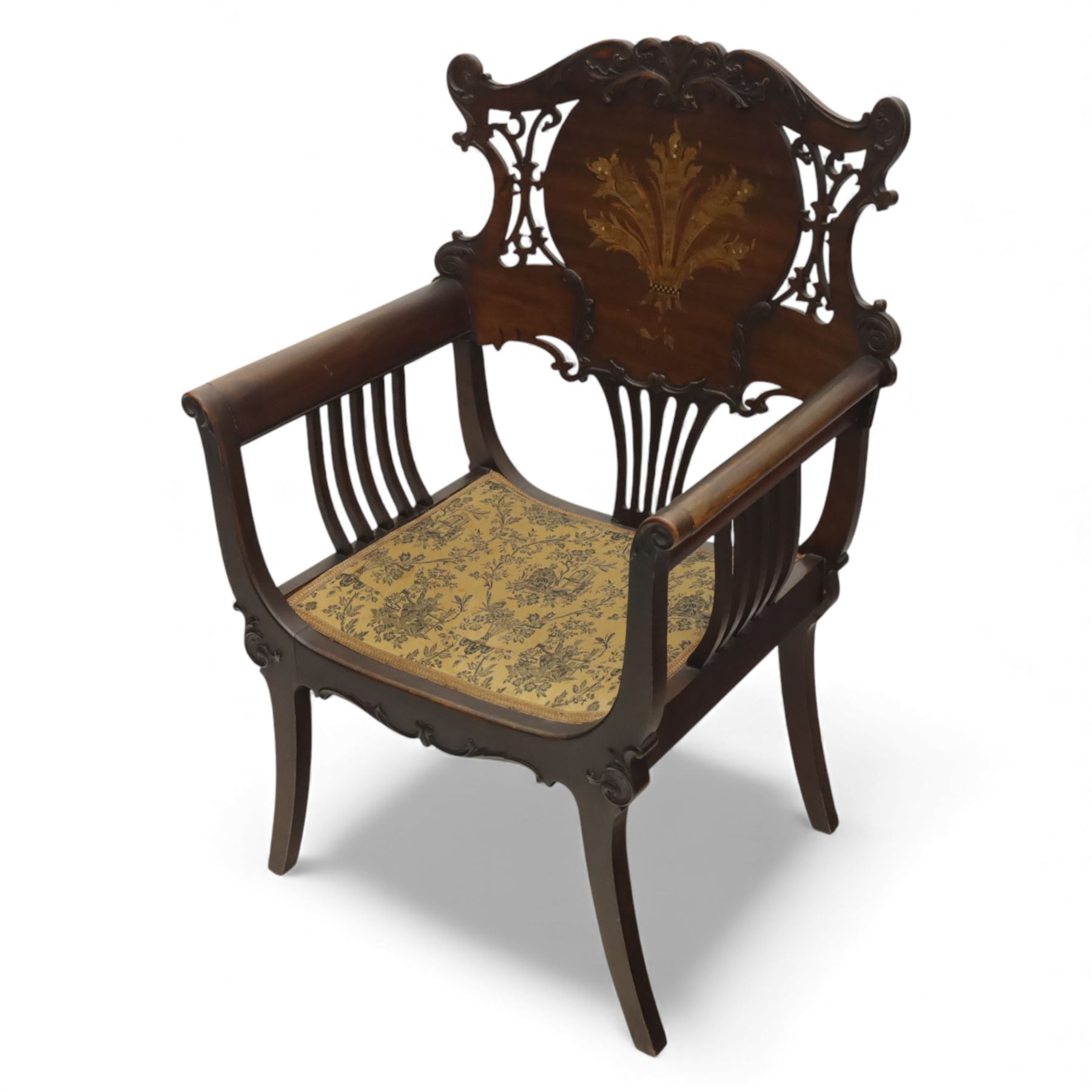 Art Nouveau mahogany open armchair in the manner of Shapland & Petter, the shaped and pierced back with foliate cresting and central panel inlaid with stylised marquetry plume, curved arms over upholstered seat, raised on sabre legs