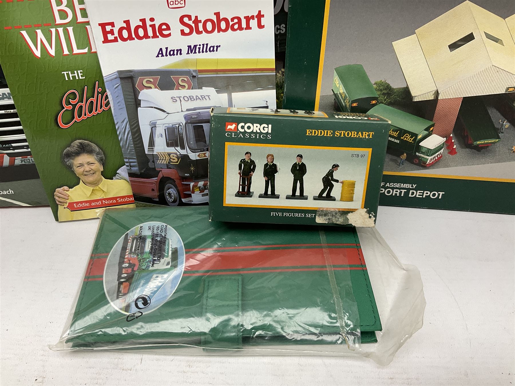 Eddie Stobart - accessories, memorabilia and promotional merchandise including Corgi Self Assembly Model Transport Depot and Five Figures Set; scarf; slippers; mugs and beakers; coasters; note book; books etc