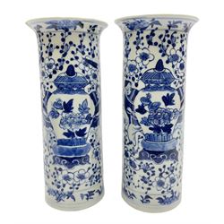 Pair of Chinese blue and white cylindrical vases, decorated with bird and flowers surrounding central figures holding a large vase, H20cm