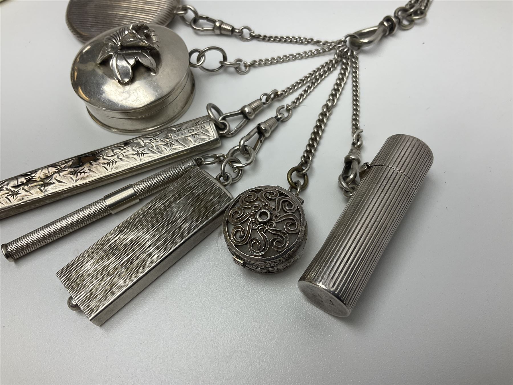 Victorian style silver chatelaine necklace, suspending eight silver sewing and similar accessories, including tape measure, needle case, pencil holder, powder compact and pill box