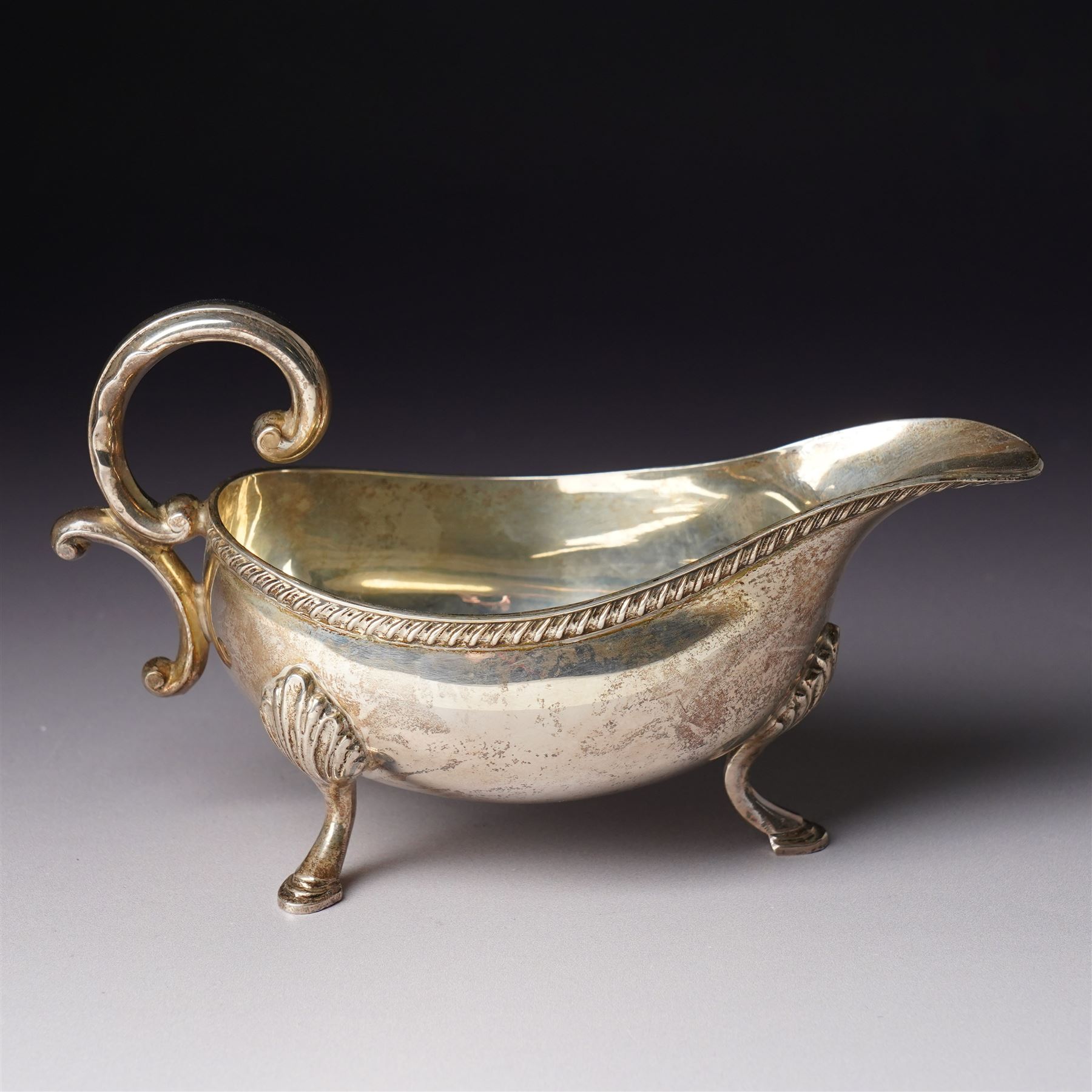 George V glass whisky noggin with hinged silver lid H10.5cm Birmingham  1912 and a silver sauce boat with C scroll handle Birmingham 1973 (2)