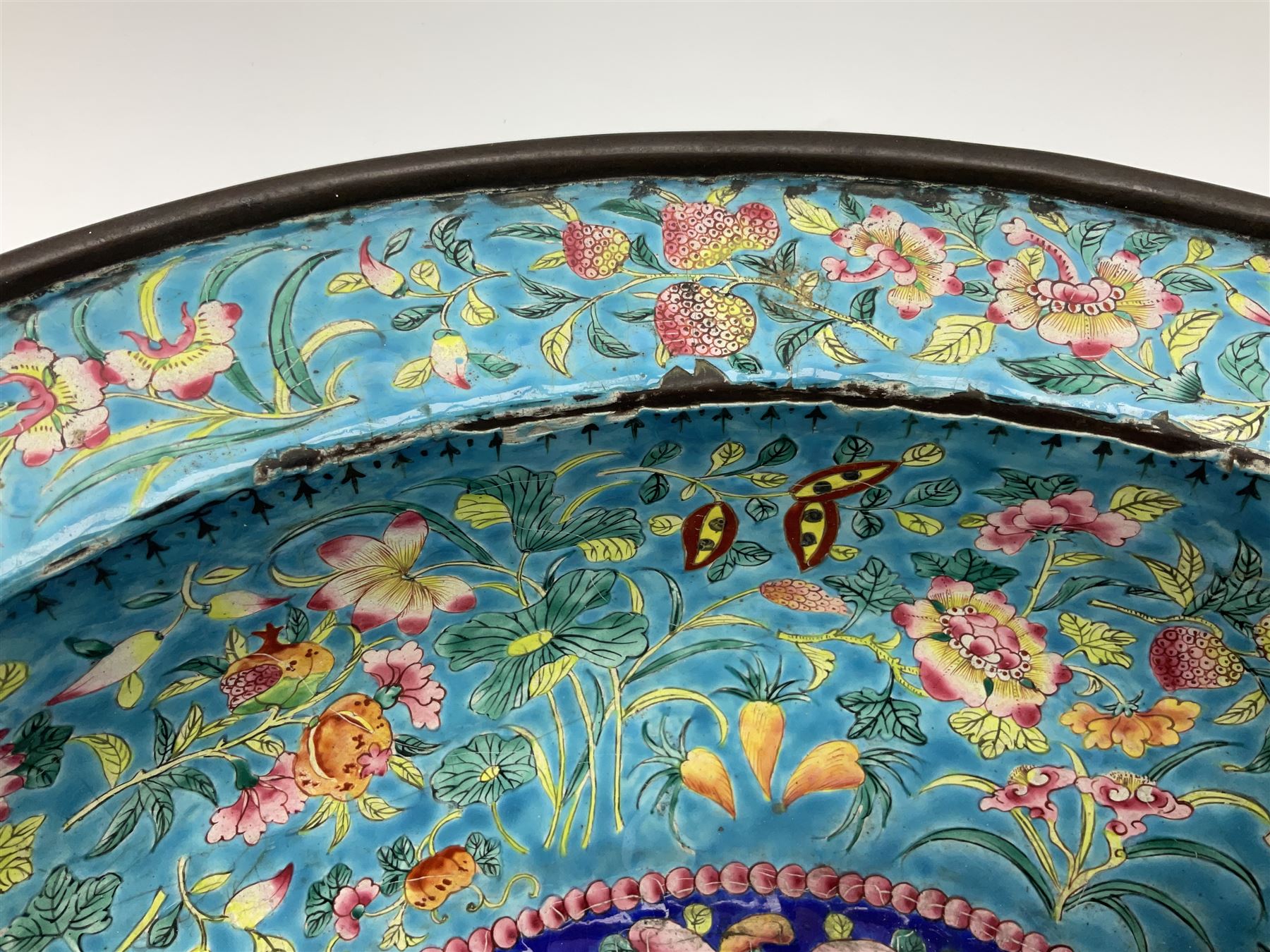 18th/19th century Chinese Canton enamel basin, the circular basin with flat everted rim, decorated with scrolling foliate and fruit decoration on a blue ground, D43cm