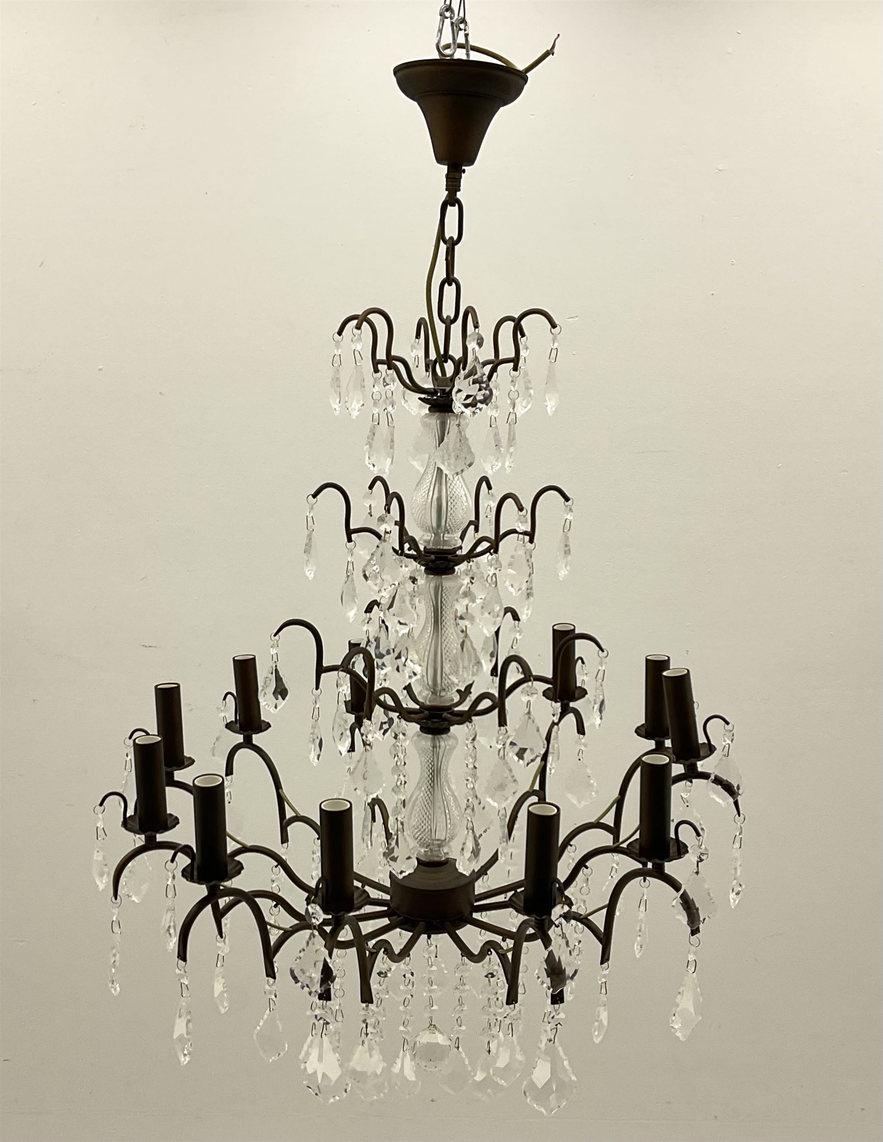 Contemporary bronze finish twelve branch chandelier, decorated with glass droplets 