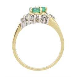 14ct gold emerald and diamond crossover ring, two oval cut emeralds with round brilliant cut diamond surround, with channel set calibre cut emerald shoulders, stamped 585