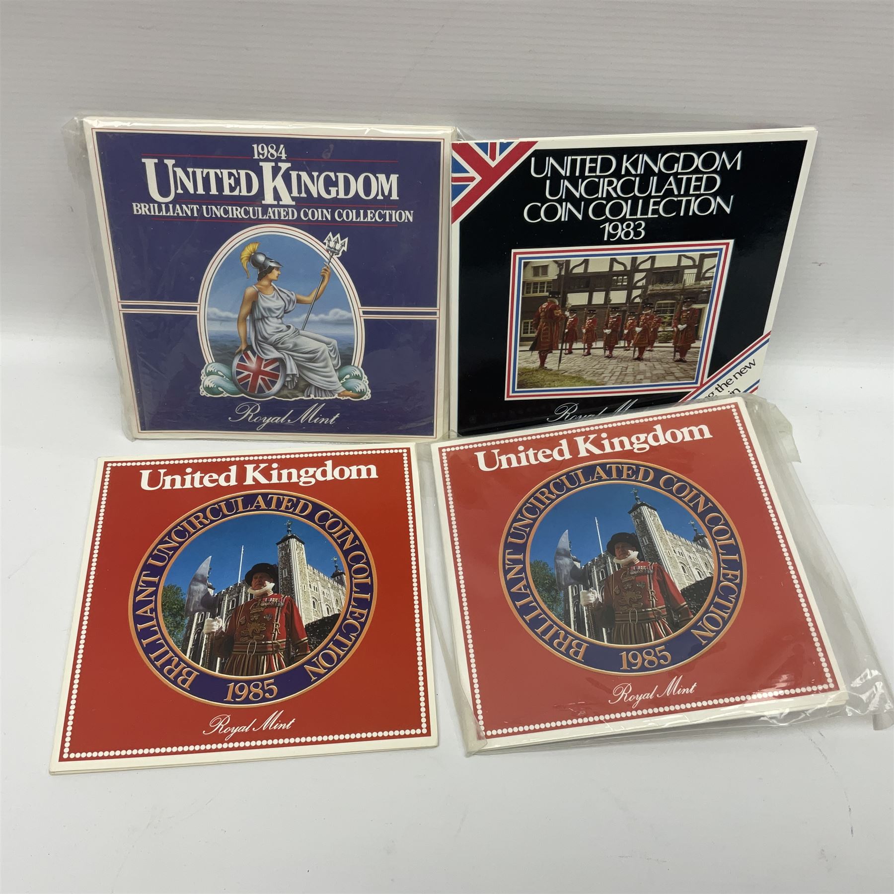 Fourteen Queen Elizabeth II United Kingdom uncirculated coin collections, dated 1983, 1984, two 1985, 1986, 1987, 1988, 1989, 1990, 1991, 1992 including dual dated 1992/1993 EEC fifty pence, 1994 and two 1995, all in card folders