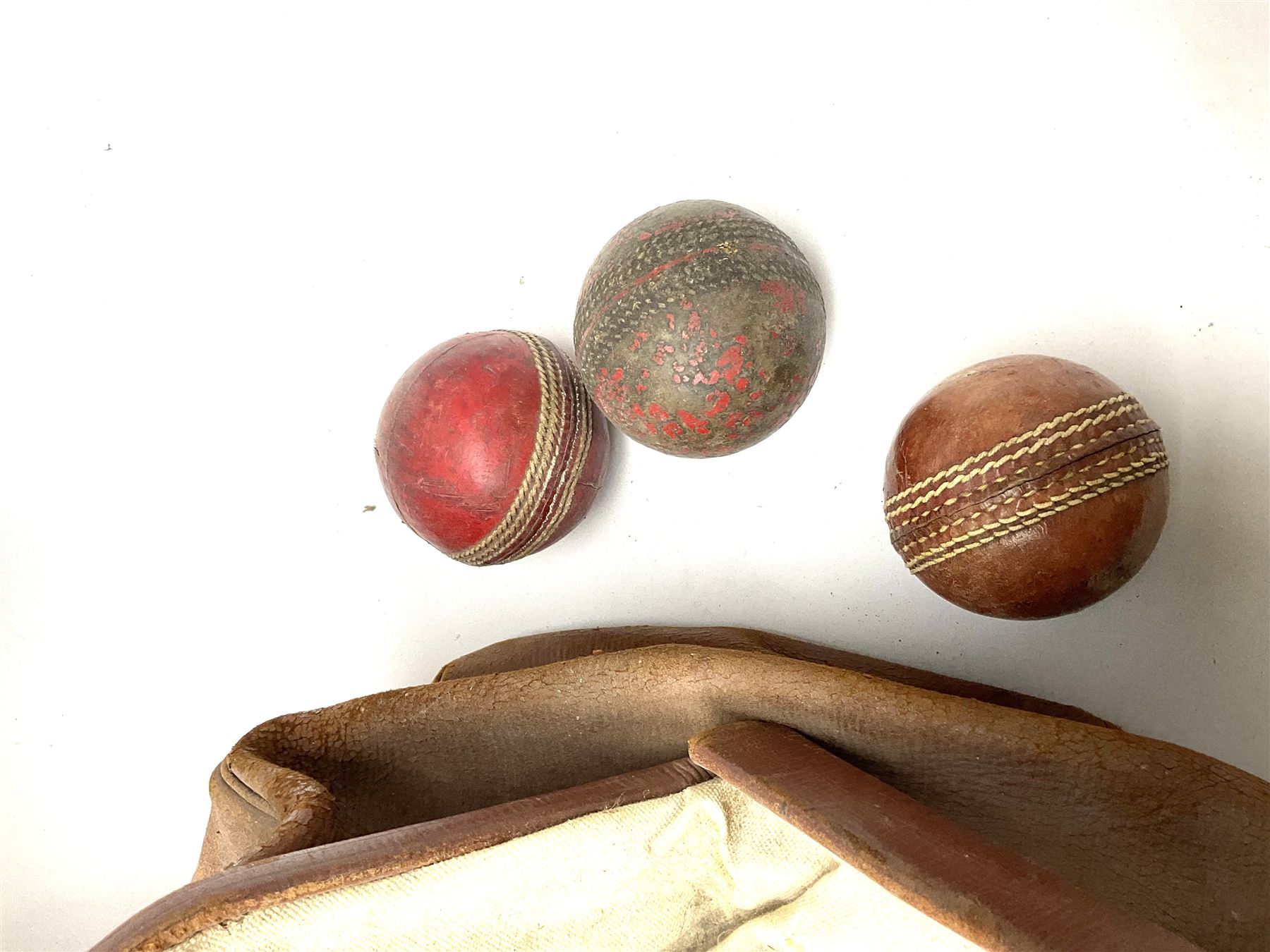 A Vintage leather cricket bag and equipment, to include cricket bats, balls, wickets, and pads. 