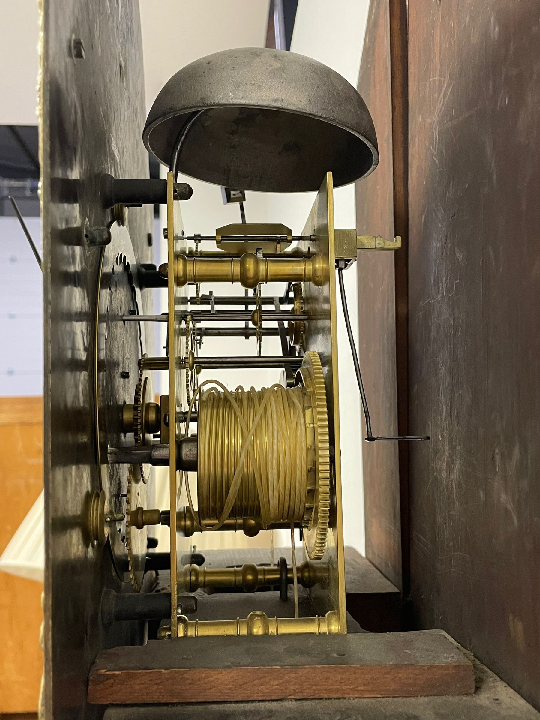 18th-century profusely carved oak longcase clock - with a pagoda pediment, upstands and carving, 
 break arch hood door flanked by reeded pilasters with brass capitals, trunk with canted corners and a spire topped door, square plinth with applied skirting, break arch brass dial with wheatsheaf engraving and cast cherub and crown spandrels, engraved break arch with the London clockmakers name John Gordin, silvered chapter ring with Roman numerals, five minute Arabic's, minute and quarter hour tracks, matted dial centre with ringed winding holes, square date aperture and seconds ring, dial pinned to a five pillar movement with inside countwheel striking, striking the hours on a cast bell. With weights and pendulum. John Gordin, is possibly a mis-spelling or phonetic spelling of John Gordon, of London, who worked from Ludgate Street in the parish of St. Gregory by St. Pauls. Apprenticed in 1689 and died in 1732 when his will was proven.
