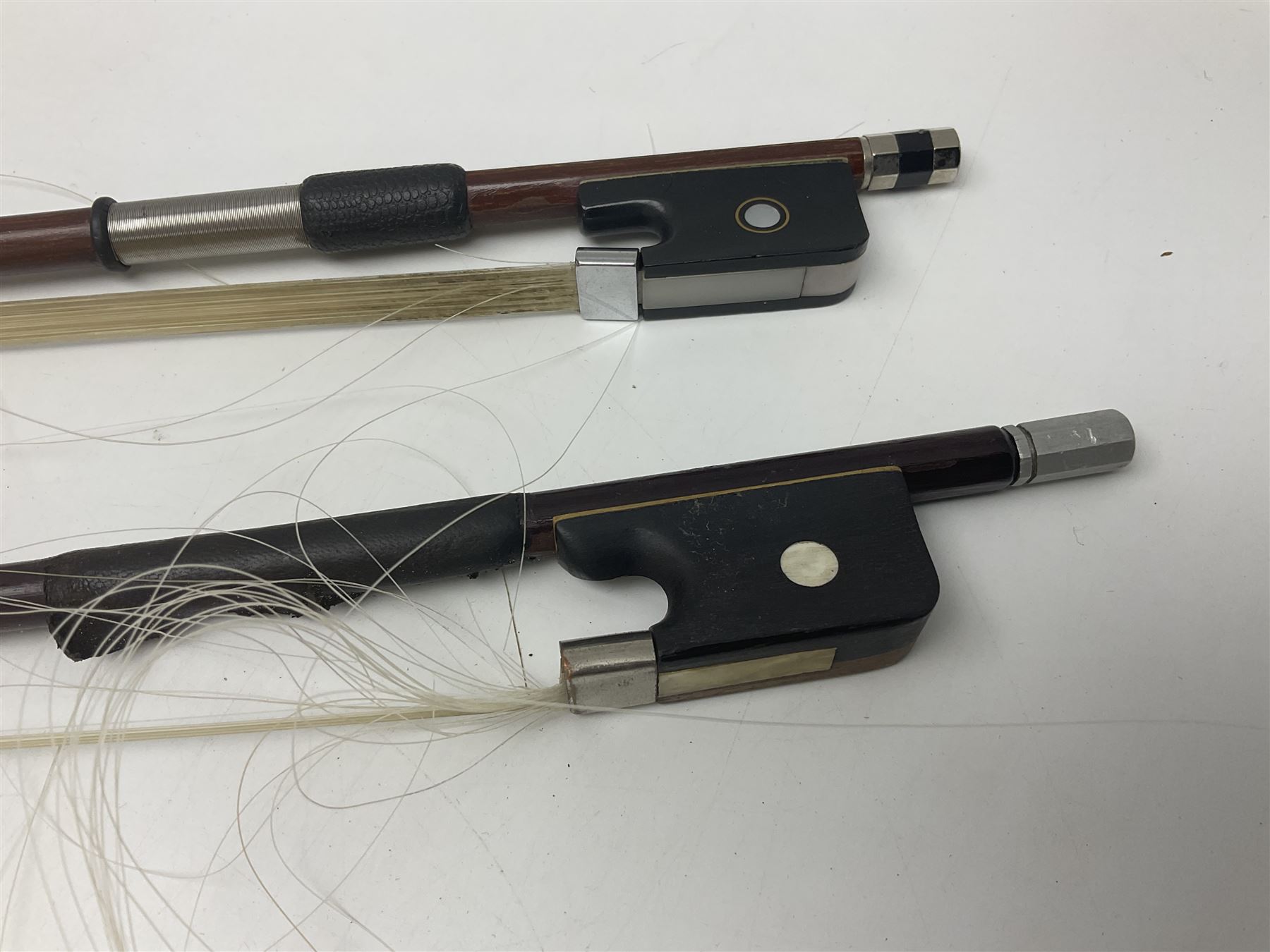 Two student half-size cellos - Boosey & Hawkes Artia with 65cm one-piece back and spruce top; bears maker's label; L104cm overall; and Romanian with 65.5cm two-piece maple back and ribs and spruce top; bears label; L108.5cm overall; each in soft carrying case with two bows (2)