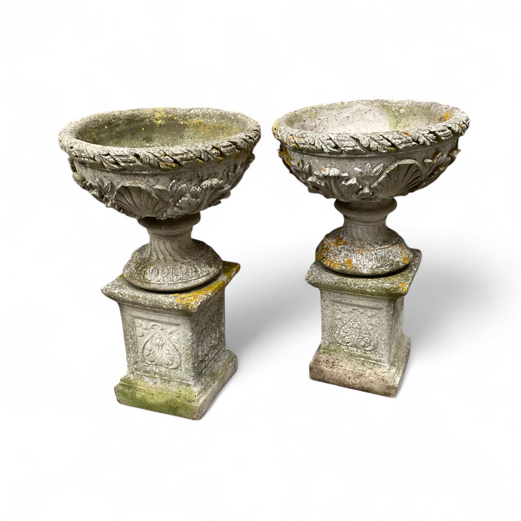 Pair of cast stone ornate garden urns, on plinth bases