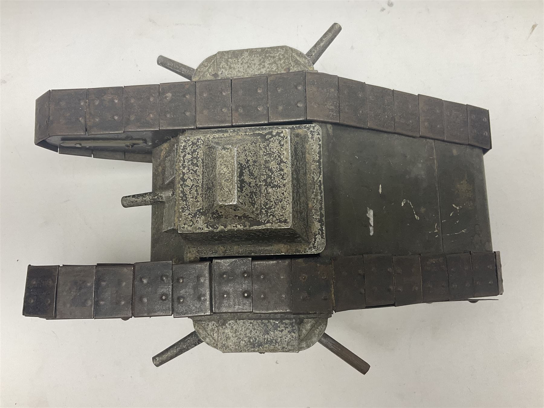 Large clockwork model of a WW1 Tank made of tin-plate and aluminium, with moving side cannons, the clockwork chain driven movement driving the articulated tin tracks; L28.5cms  W16.5cms and H13.5cms