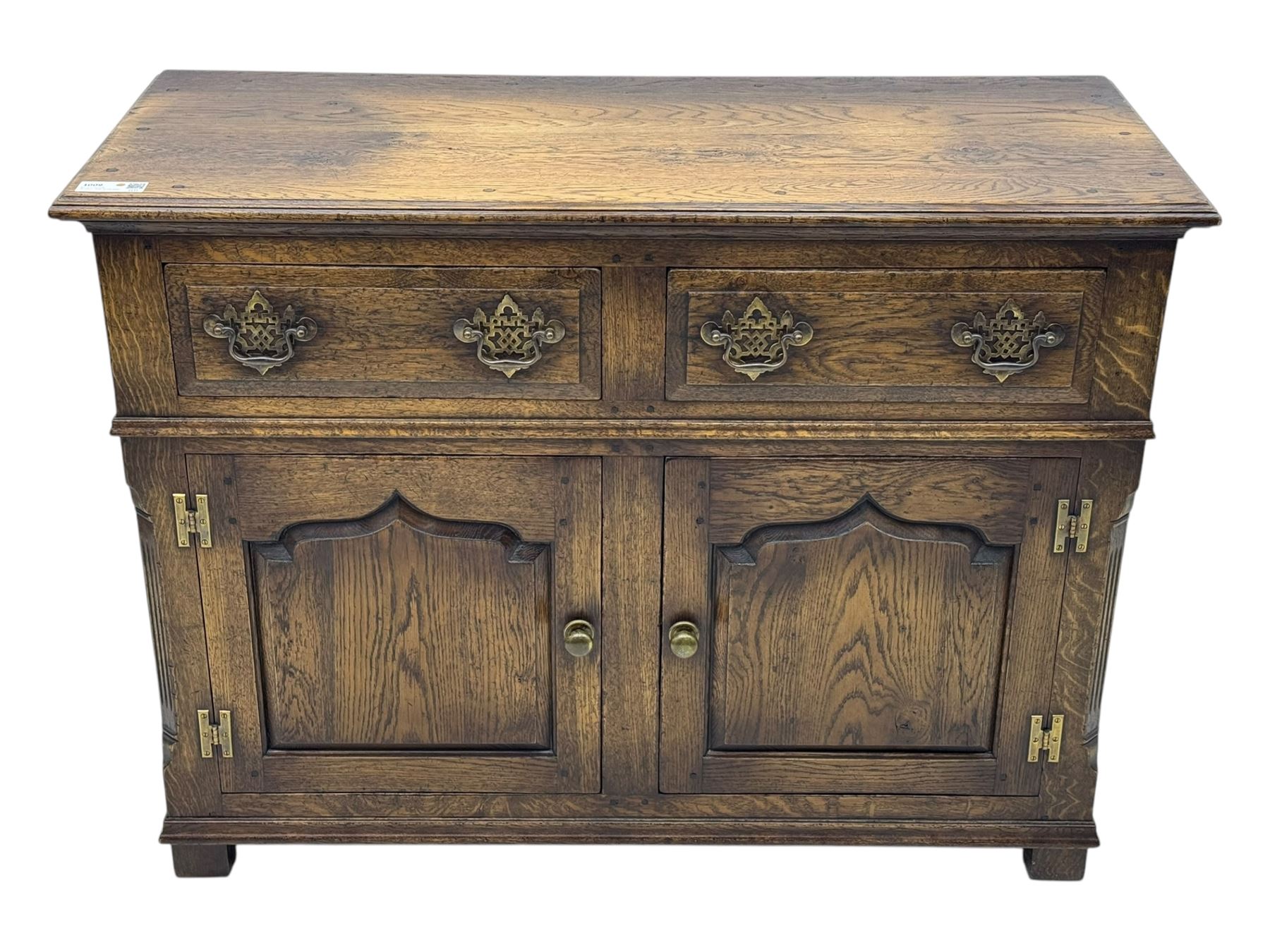 Early 20th century Jacobean design oak dresser sideboard, rectangular top with moulded edge over two baize-lined drawers with pierced handles, above two fielded panel cupboard doors, on stile supports