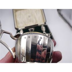 1920s silver six piece cruet set, comprising two mustard pots with covers, two open salts and two pepper pots, all of circular faceted form, mustards and salts with blue glass liners, hallmarked Mappin & Webb, Birmingham 1928, with four matched silver condiment spoons, hallmarked, contained within fitted case 