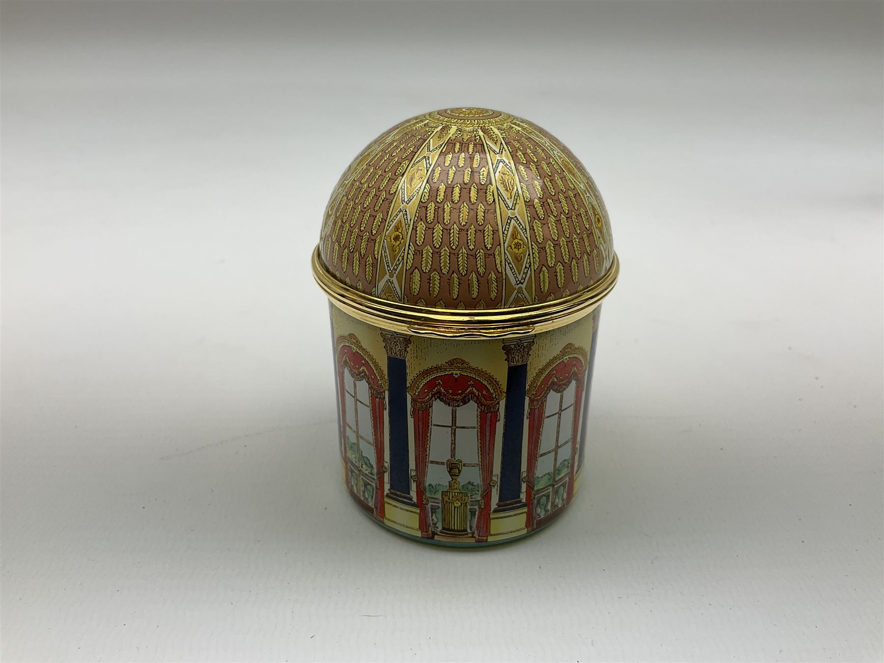 Cylindrical music box with domed lid depicting the Music Room at Buckingham Palace and playing Mozart's 'Voi Che Sapete', limited edition 187 of 250, boxed, together with enamel box for the silver jubilee and a victorian paperweight of Scarbrough  