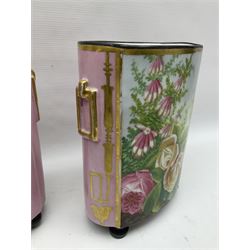 Pair of continental hand painted cachepots, decorated with roses and flowers with gilt detail to the faux handles, raised upon bun feet, H27cm, W19cm 