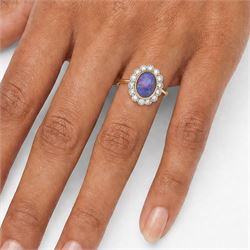 18ct gold black opal diamond cluster ring, single oval cabochon cut opal of 2.76 carat, surrounded by fourteen round brilliant cut diamonds, London 1998, total diamond weight 0.60 carat