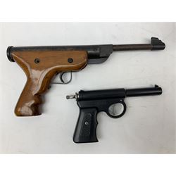 Two air pistols, together with a target and two tins of pellets and a leather gun belt