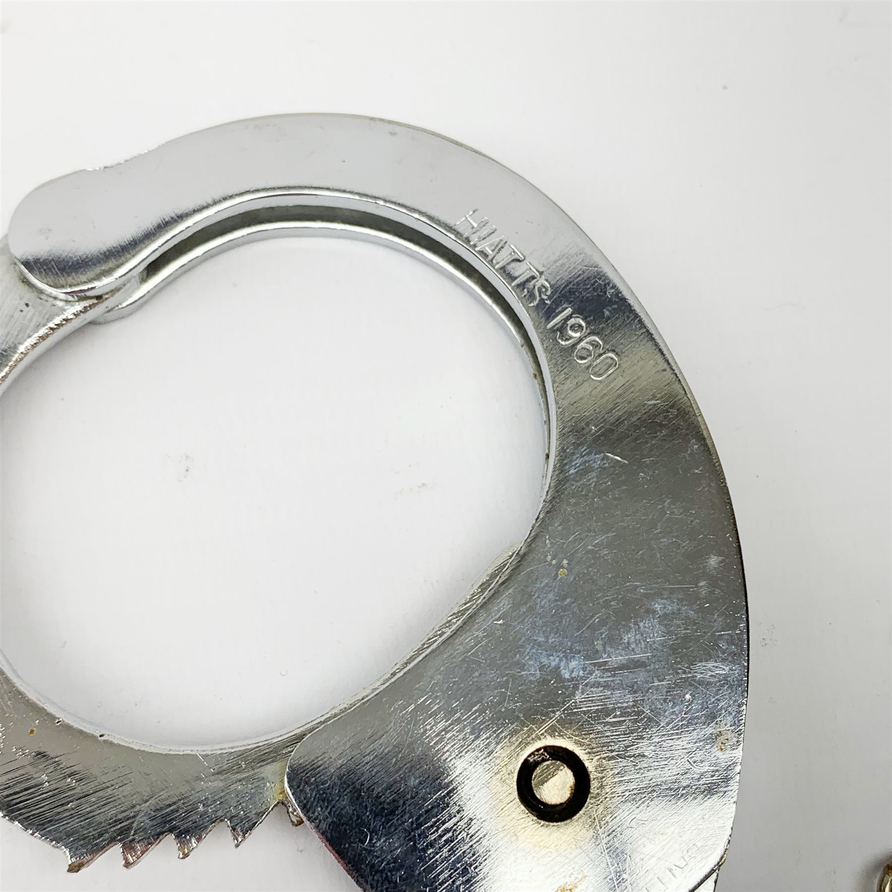 Pair of 1960's Hiatt chromium plated handcuffs with key and a 'Metropolitan' whistle