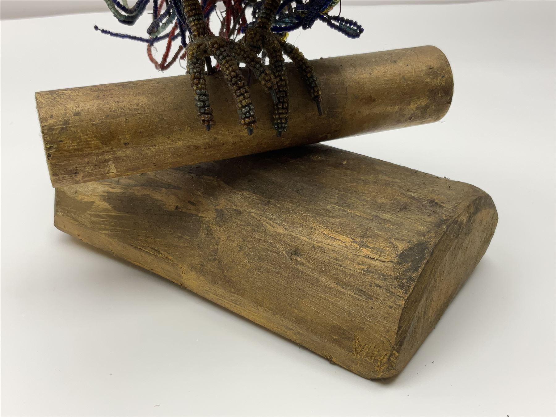Victorian bead and wire model of a parrot, of polychrome beads, with glass eyes, on a wooden base, H24cm