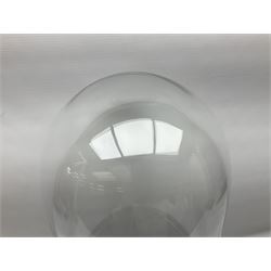 Large glass dome upon circular base, H63cm