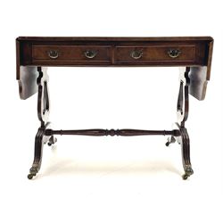 20th century walnut drop leaf sofa table, shaped drop leaf top over two drawers, on lyre shaped end pillars with splayed reeded supports joined by turned stretcher