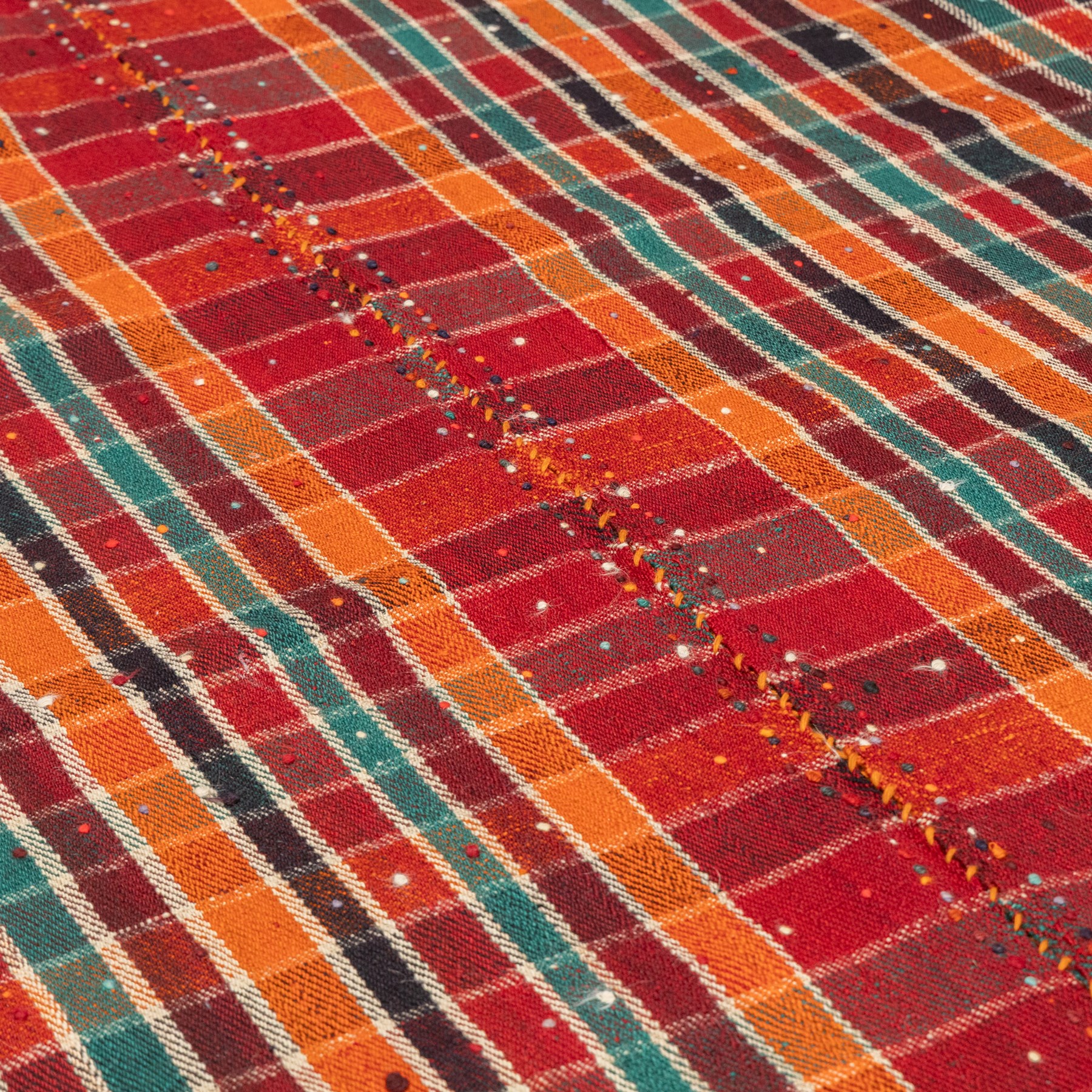 South West Persian Jajim kilim, formed from two joined flatwoven panels, patterned with intersecting stripes in red, orange, green, dark brown and ivory forming a checked design, scattered coloured dot motifs, multicoloured wool tassels along the sides